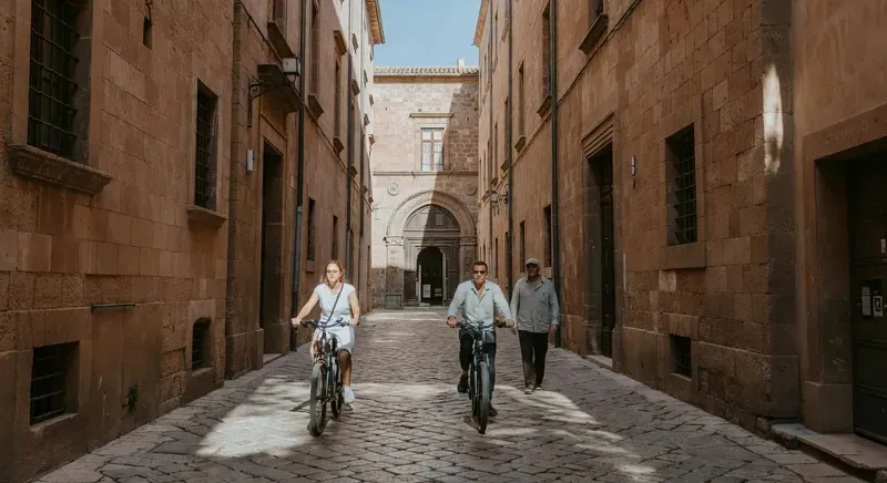 Guided e-bike riders exploring the historic Castello district of Cagliari on a sardinia cycling tour through ancient streets and panoramic viewpoints